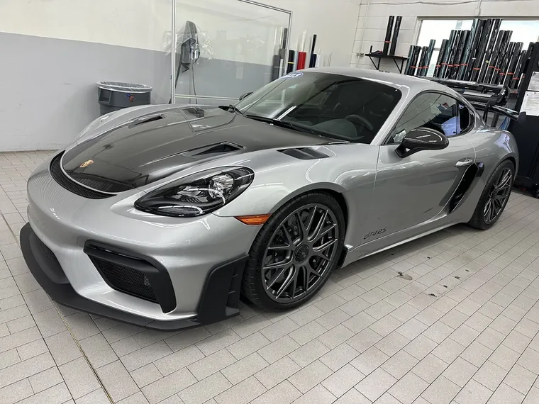 A silver Porsche 718 with tinted windows in the Murphys workshop