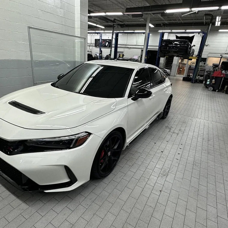 A white Honda Civic Type R with tinted windows